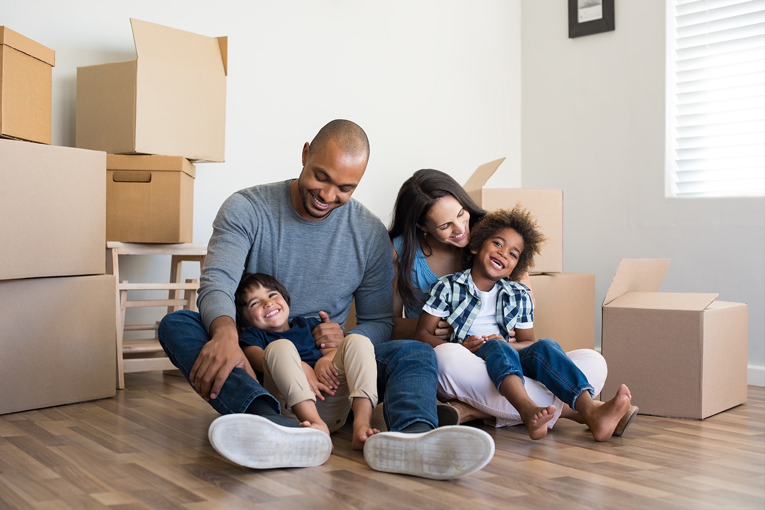 family smiling while unpacking their house